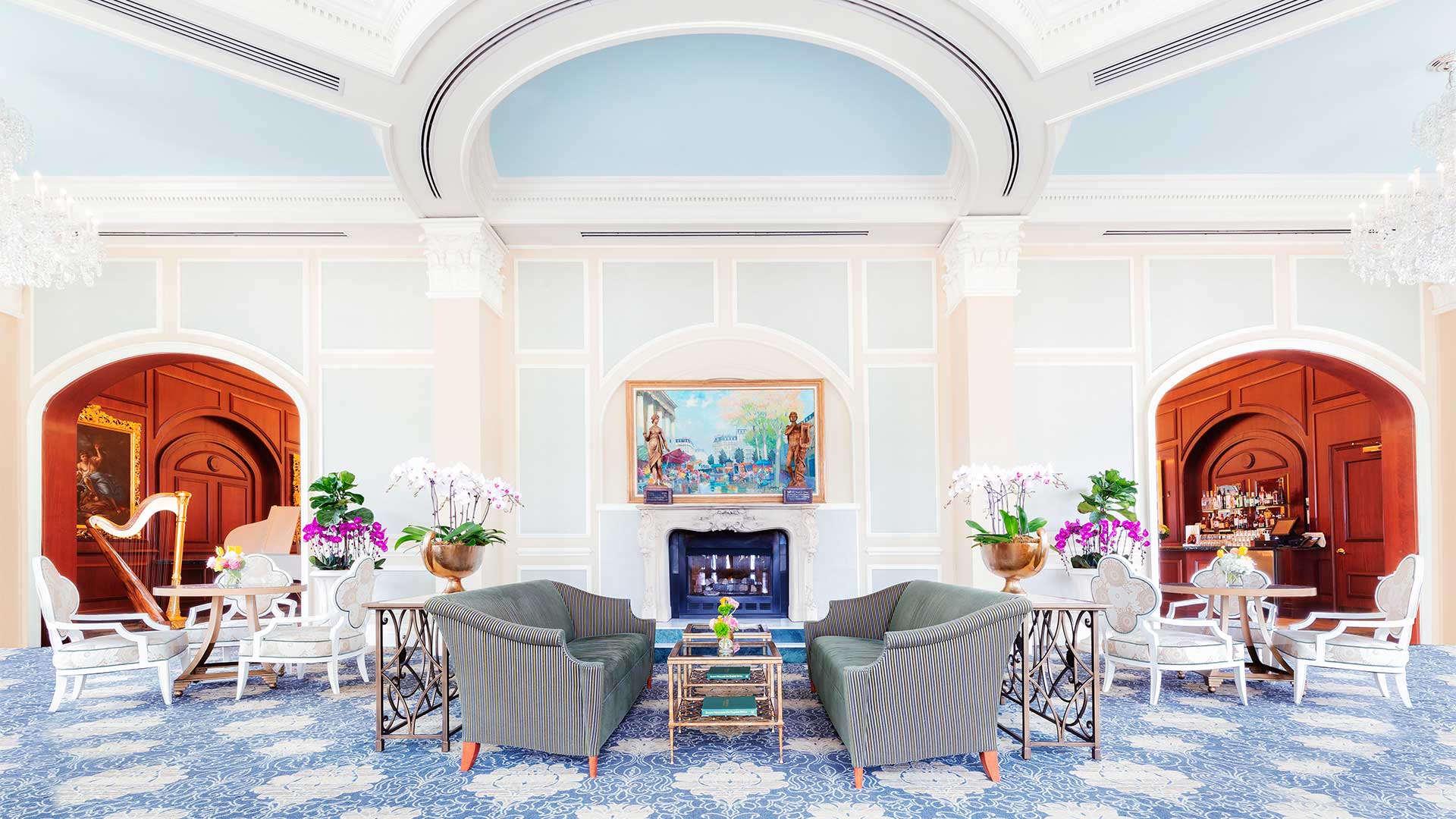 large blue room with lots of seating and art