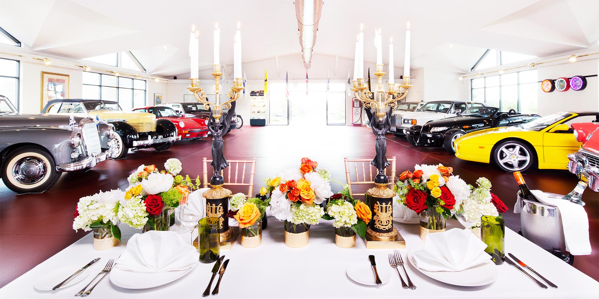 car showroom with table in front with flowers and candles