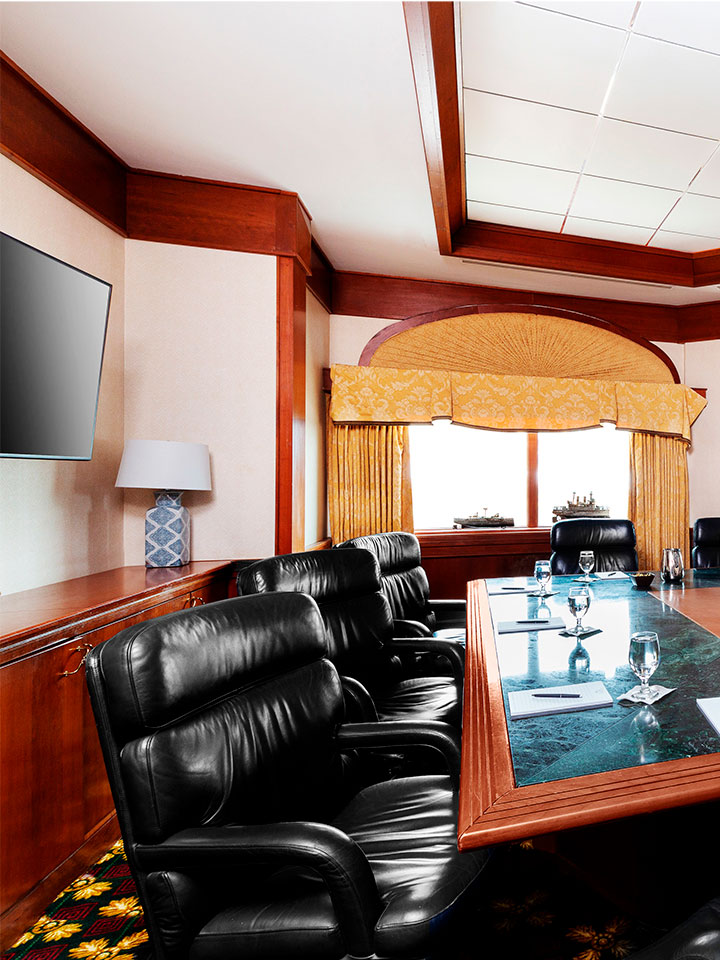 Office room with black office chairs surrounding a green marble table