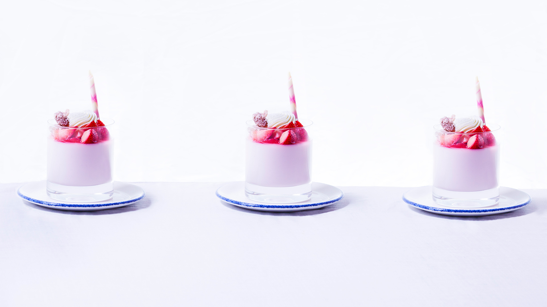 three pink strawberry desserts in a cup