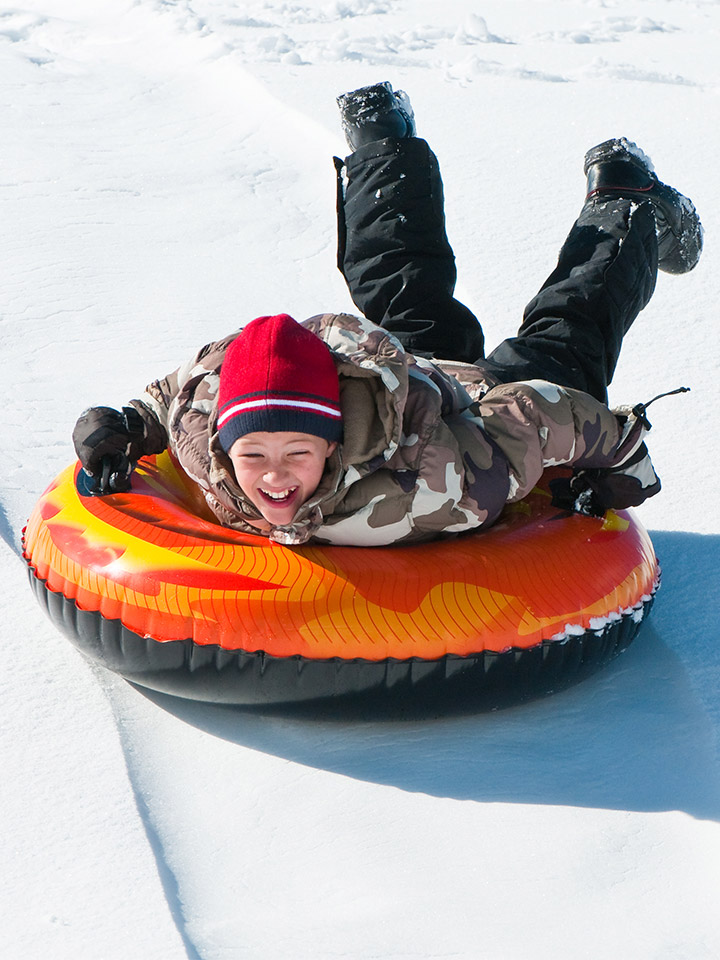 boy on snow tube